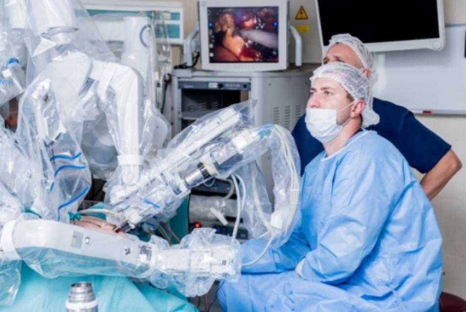 Surgeon performing medical surgery with robotic arm