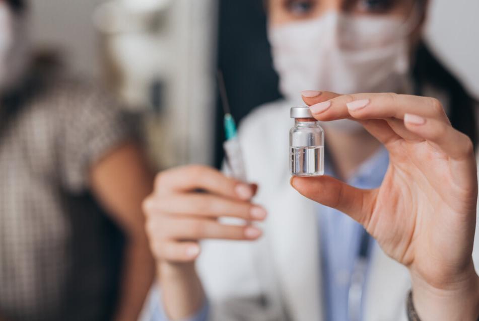 Doctor holding a vaccine shot