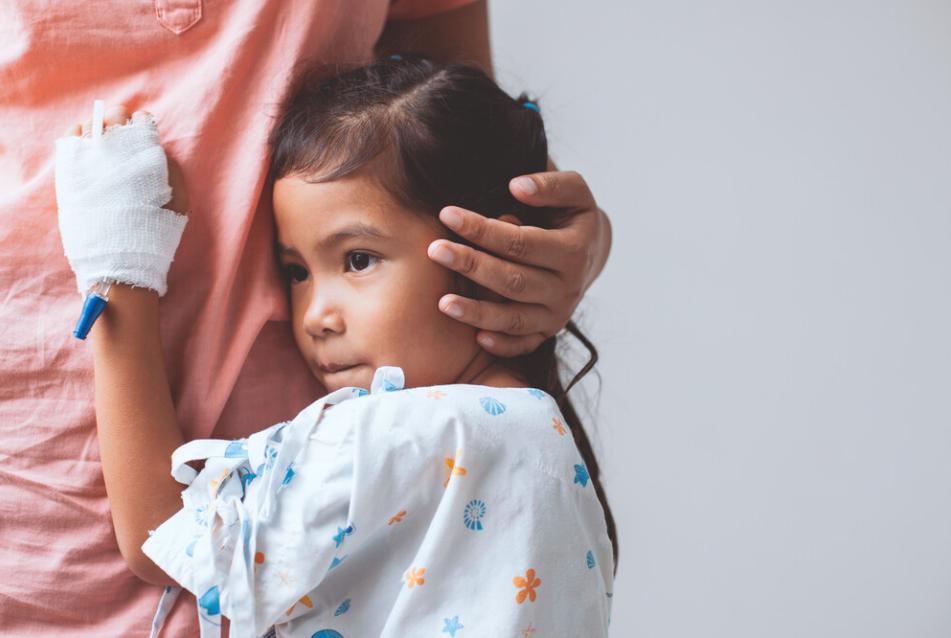 girl treated at hospital with hand bandage